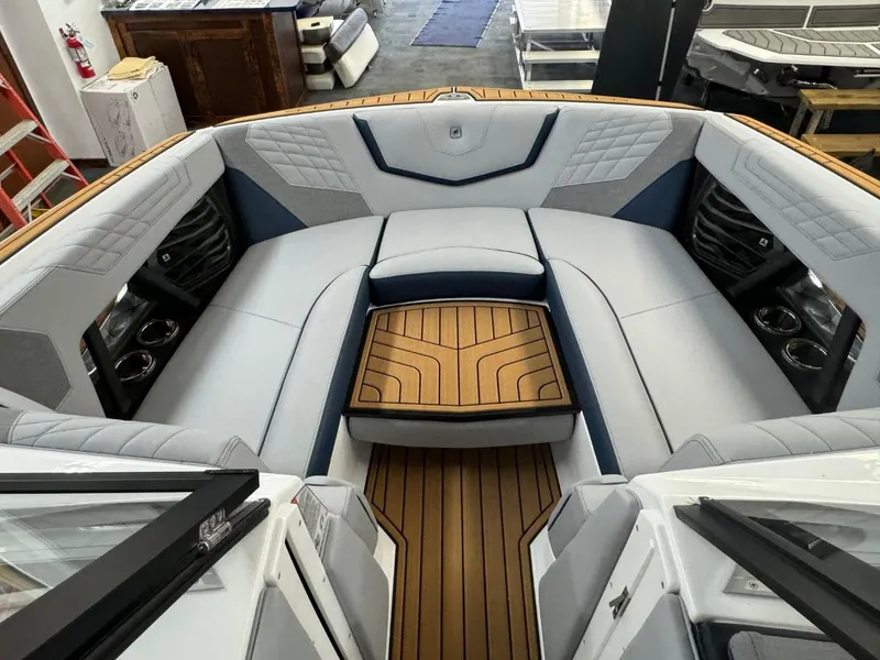 Slide: The Image of 2024 Nautique Super Air Nautique G23 boat interior with luxurious seating and teak flooring. - 46