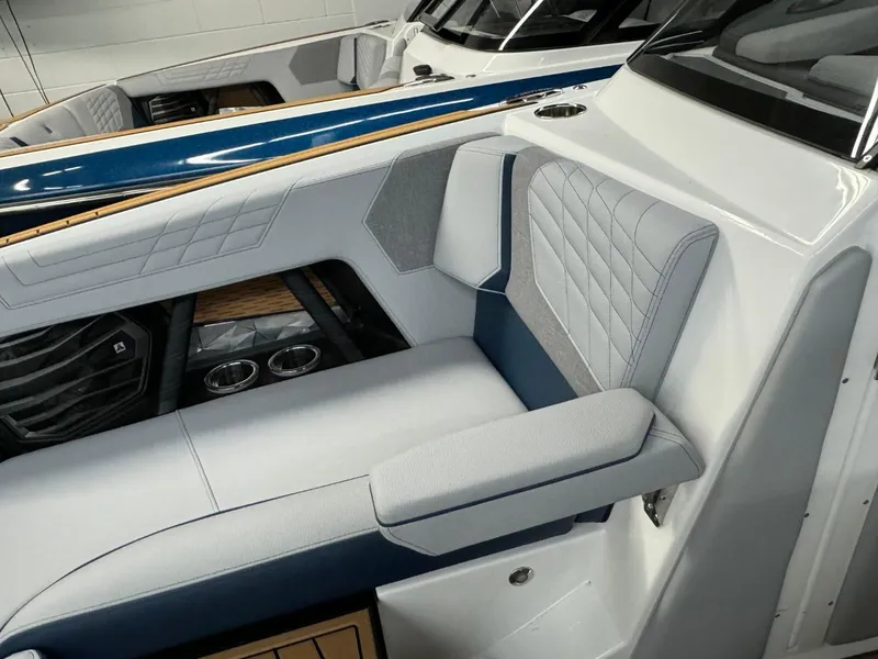 Slide: The Image of 2024 Nautique Super Air Nautique G23 interior with luxurious seating and cup holders. - 48