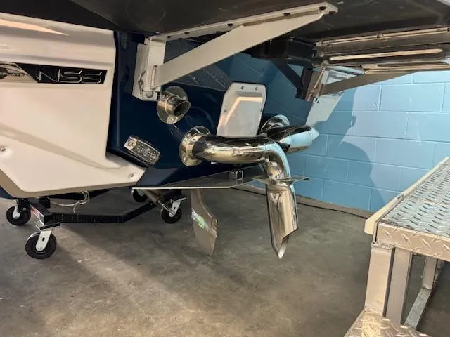 Slide: The Image of 2024 Nautique Super Air Nautique G23 boat stern with NSS system in a garage. - 7