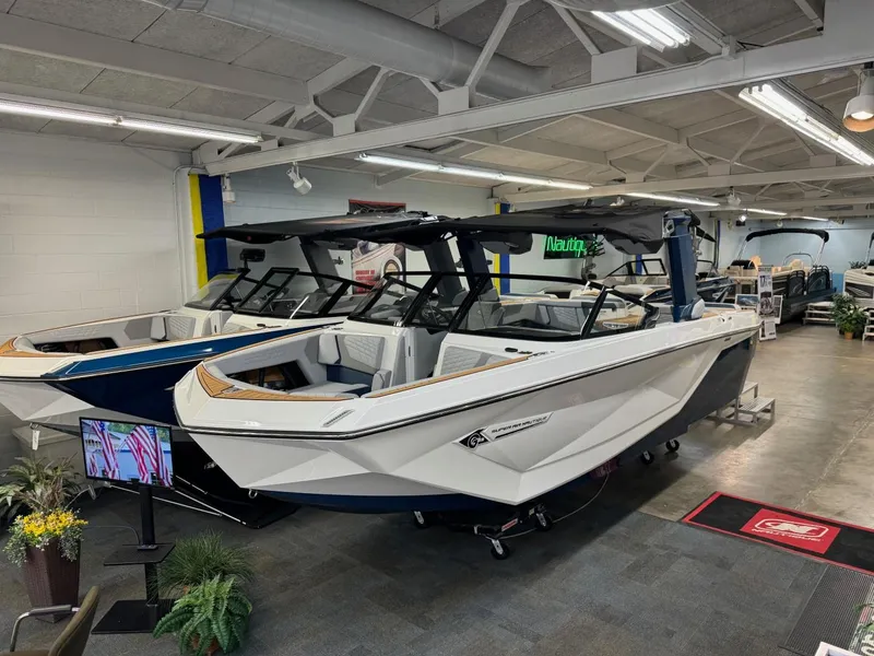 Slide: The Image of 2024 Nautique Super Air Nautique G23 boat displayed in showroom. - 9