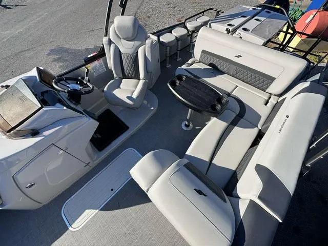 Slide: The Image of 2025 Starcraft CX 23 DL BAR boat interior with plush seating and modern helm. - 3