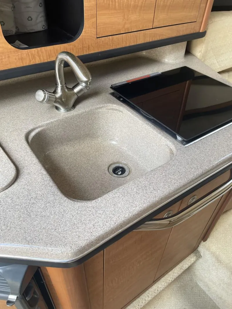 Slide: The Image of 2006 Sea Ray 270 Amberjack kitchen sink and countertop with modern faucet. - 10