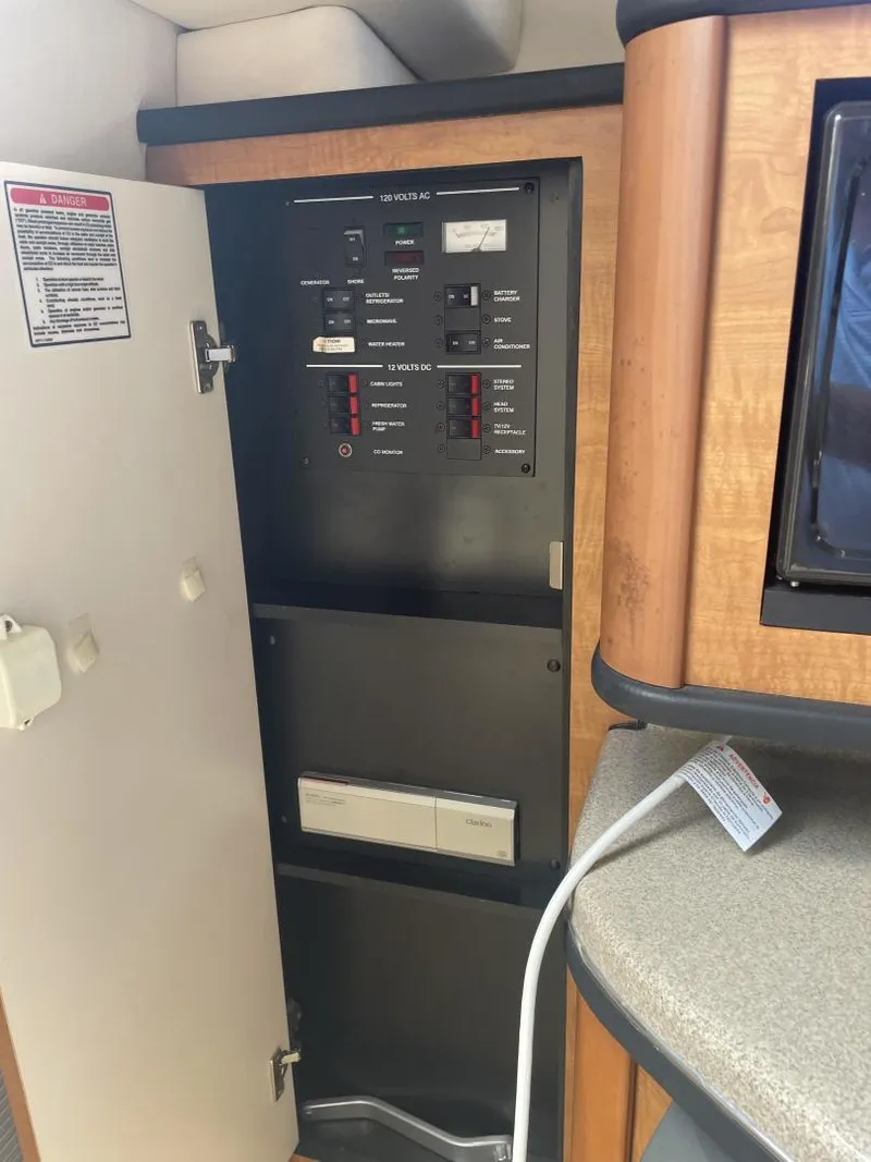 Slide: The Image of 2006 Sea Ray 270 Amberjack electrical panel inside cabin. - 15