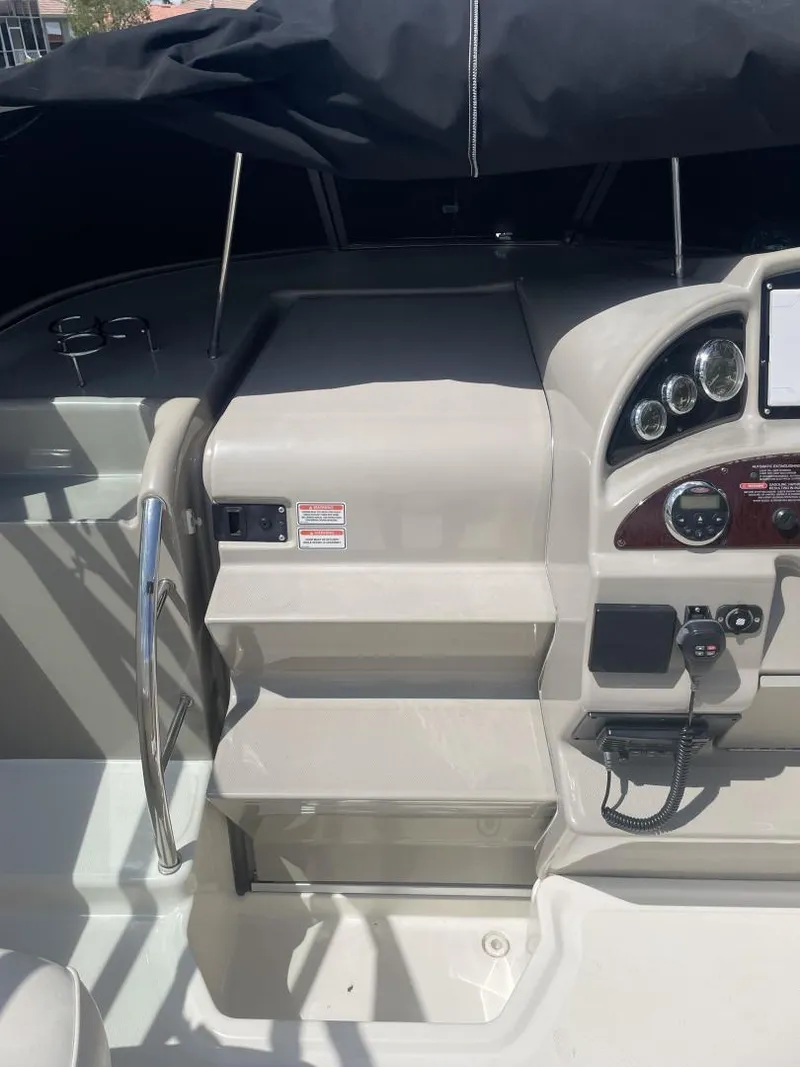 Slide: The Image of 2006 Sea Ray 270 Amberjack boat cockpit with steering controls and dashboard. - 18