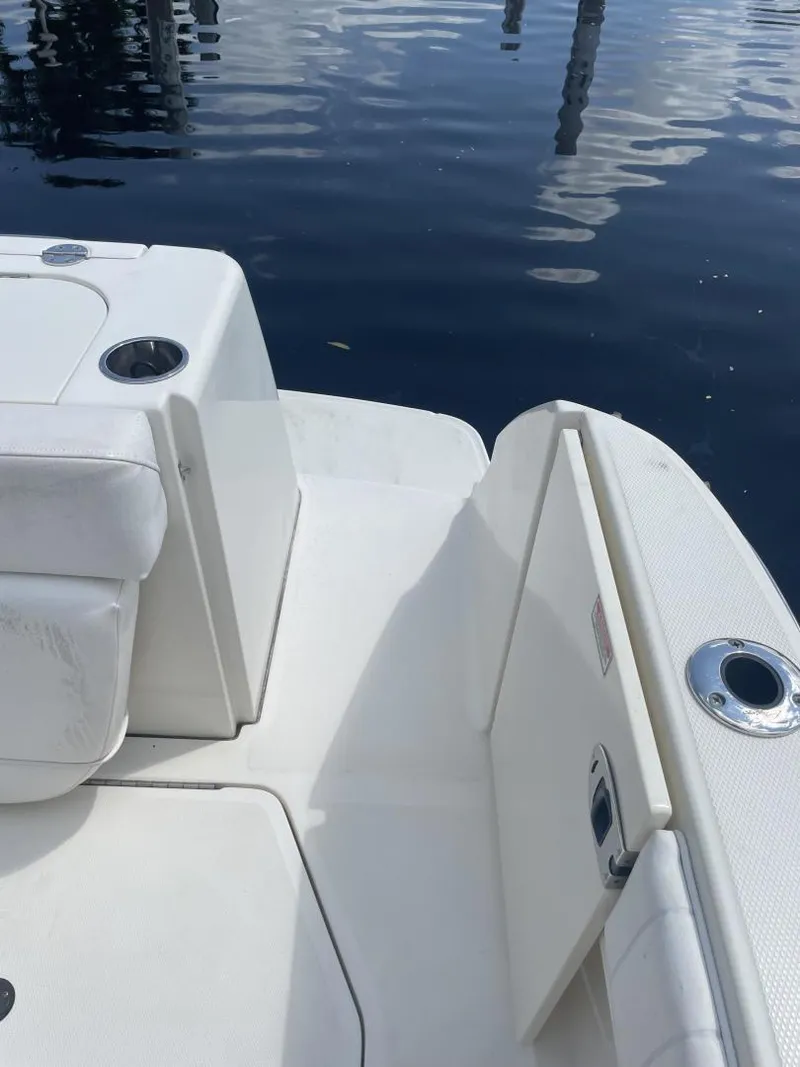 Slide: The Image of 2006 Sea Ray 270 Amberjack boat deck with seating and cup holders by the water. - 22