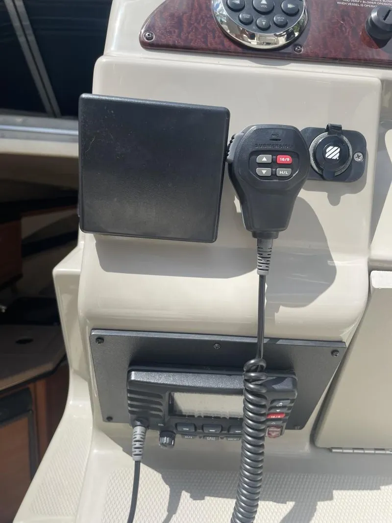 Slide: The Image of Control panel of a 2006 Sea Ray 270 Amberjack boat with radio equipment. - 24