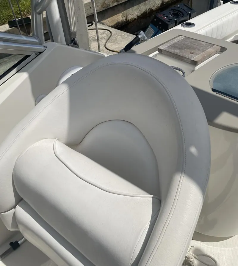 Slide: The Image of 2006 Sea Ray 270 Amberjack boat interior with white leather seating. - 25