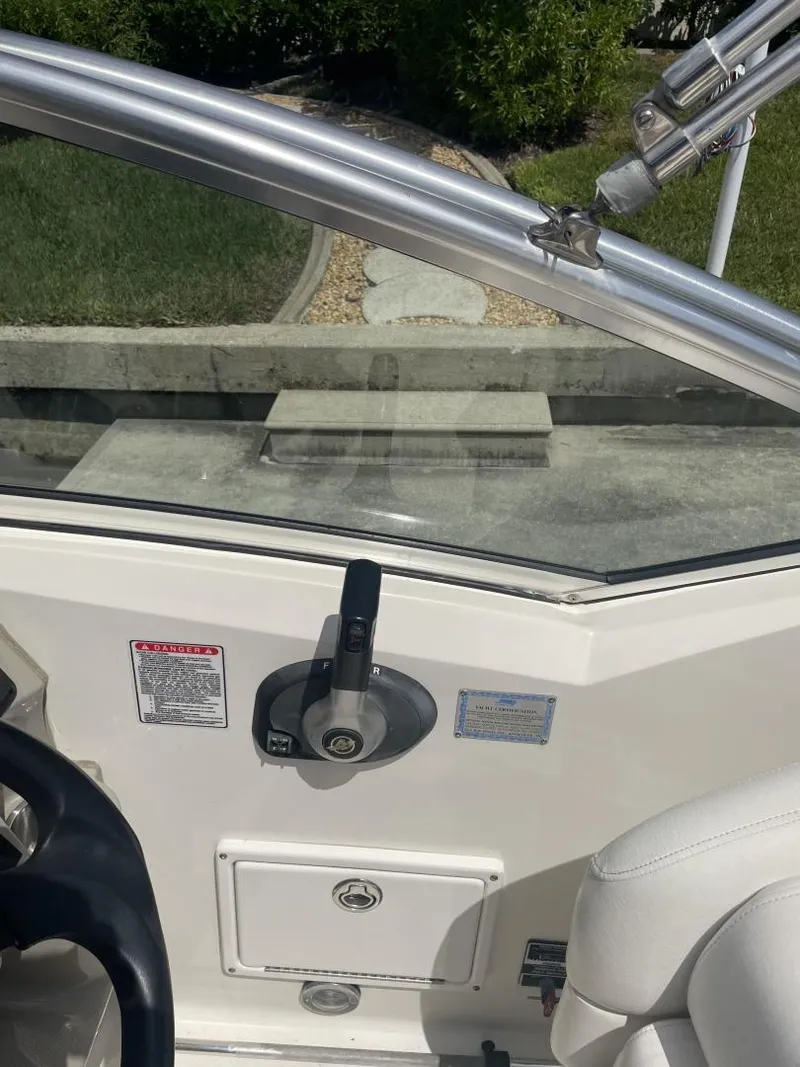 Slide: The Image of 2006 Sea Ray 270 Amberjack boat interior with control panel and seating. - 26