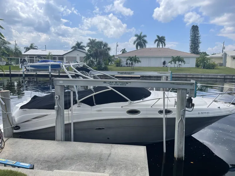 Slide: The Image of 2006 Sea Ray 270 Amberjack boat docked in a residential canal setting. - 3