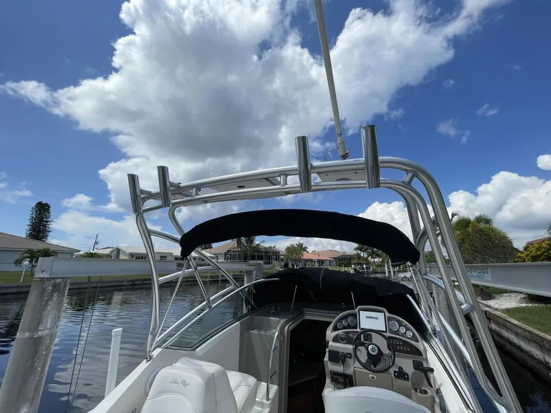 Slide: The Image of 2006 Sea Ray 270 Amberjack boat docked under a cloudy sky. - 30