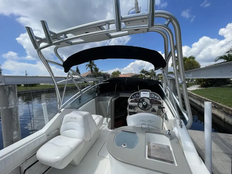 Slide: The Image of 2006 Sea Ray 270 Amberjack boat with sleek design, docked under a sunny sky. - 31