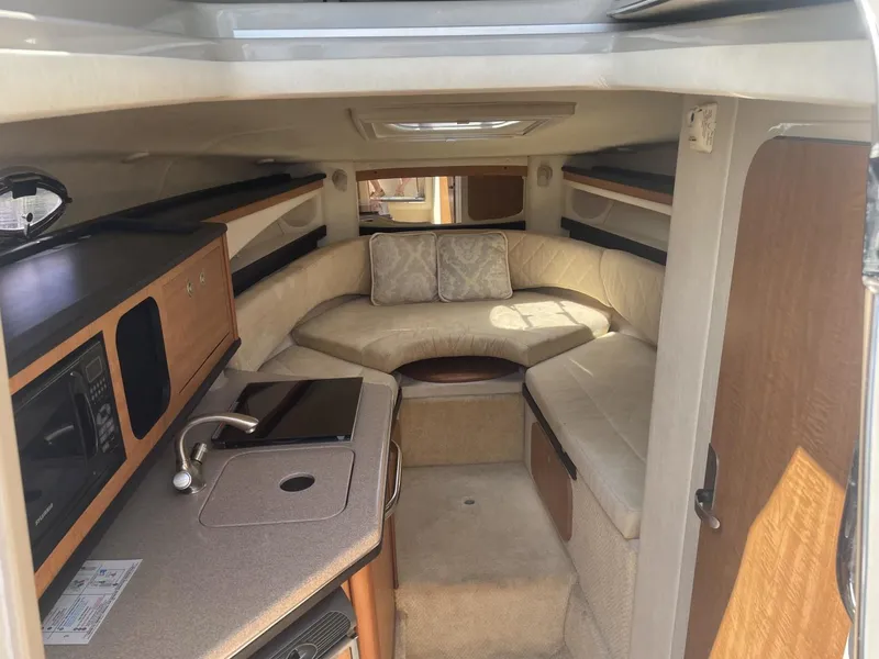 Slide: The Image of Interior of 2006 Sea Ray 270 Amberjack boat with kitchenette and seating area. - 4