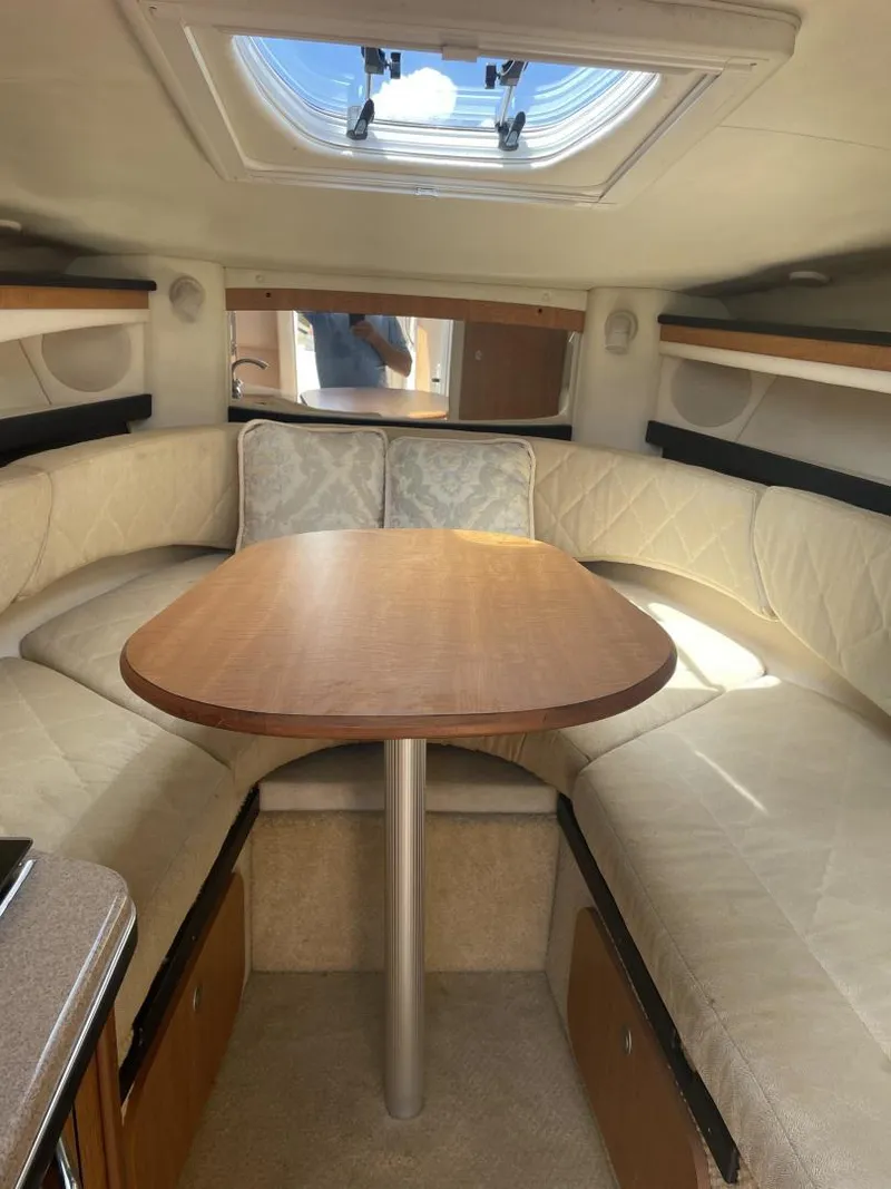 Slide: The Image of 2006 Sea Ray 270 Amberjack cabin interior with dining table and seating. - 8