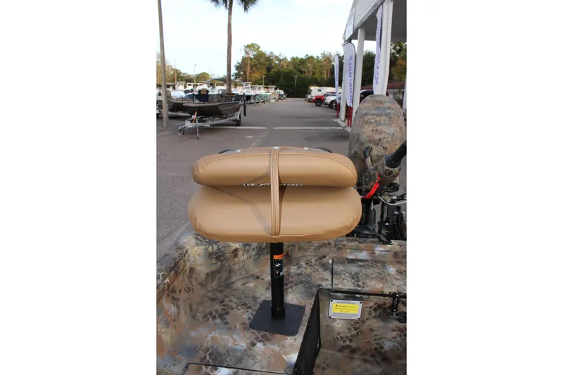 Slide: The Image of 2025 Excel 1751 Viper F4 boat seat, tan color, in a dealership lot. - 11