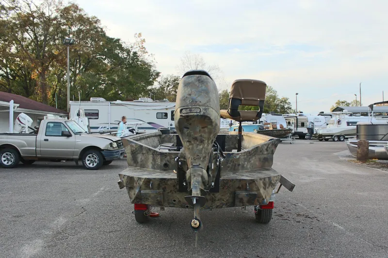 Slide: The Image of 2025 Excel 1751 Viper F4 boat with camo design in a dealership lot. - 6