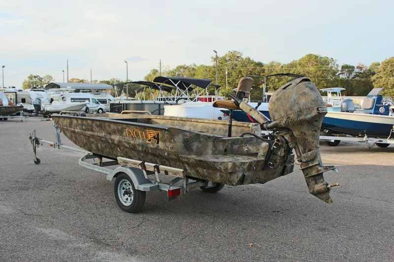 Slide: The Image of 2025 Excel 1751 Viper F4 boat with camouflage design on a trailer in a parking lot. - 7