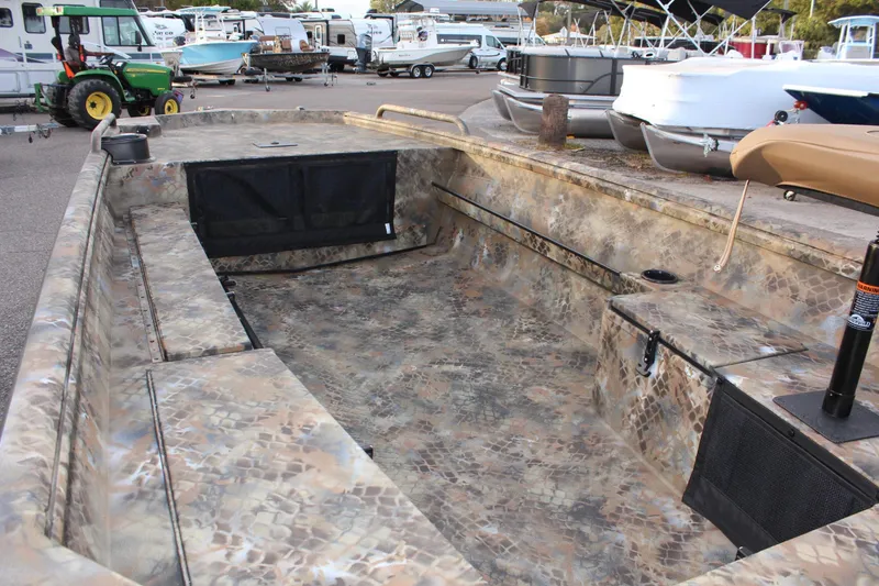 Slide: The Image of 2025 Excel 1751 Viper F4 boat with camouflage interior, parked in a marina. - 9