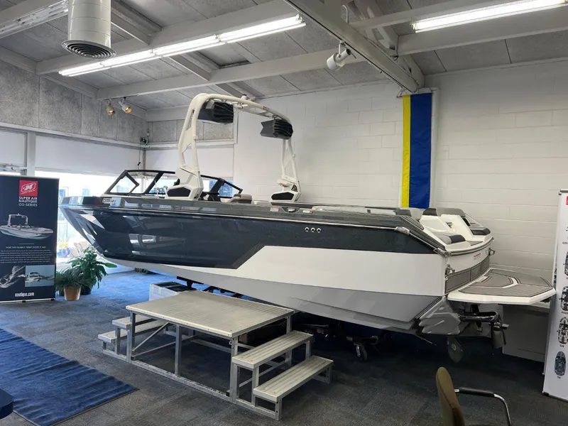 Slide: The Image of 2024 Nautique Super Air Nautique GS24 boat displayed indoors. - 3