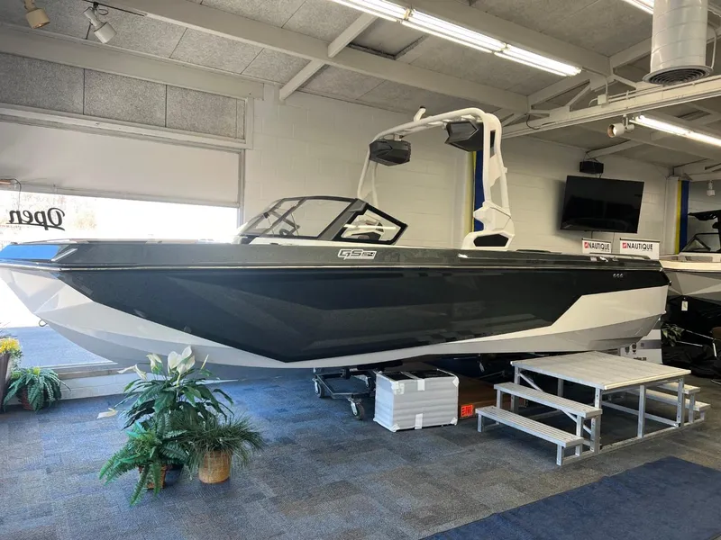 Slide: The Image of 2024 Nautique Super Air Nautique GS24 boat displayed indoors. - 4