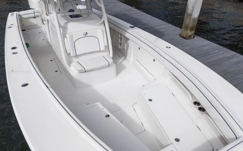 Slide: The Image of 2017 Jupiter 34 HFS boat interior, white seating, docked by water. - 13