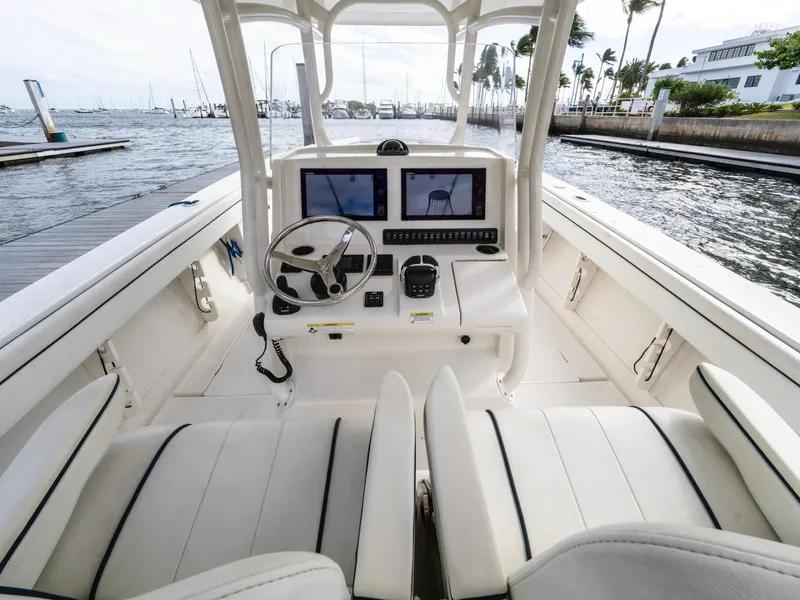 Slide: The Image of 2017 Jupiter 34 HFS boat cockpit with dual screens and steering wheel. - 17