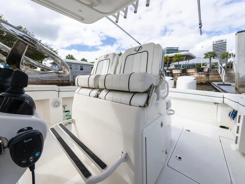 Slide: The Image of 2017 Jupiter 34 HFS boat interior with white seating and steering wheel. - 18