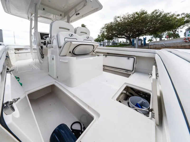 Slide: The Image of 2017 Jupiter 34 HFS boat interior with open storage compartments and seating. - 21