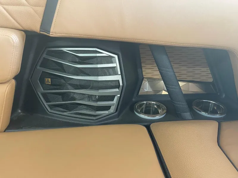 Slide: The Image of 2024 Nautique Super Air Nautique G23 interior with speaker and cup holders. - 11