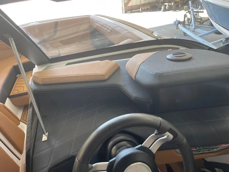 Slide: The Image of 2024 Nautique Super Air Nautique G23 dashboard with steering wheel and controls. - 14