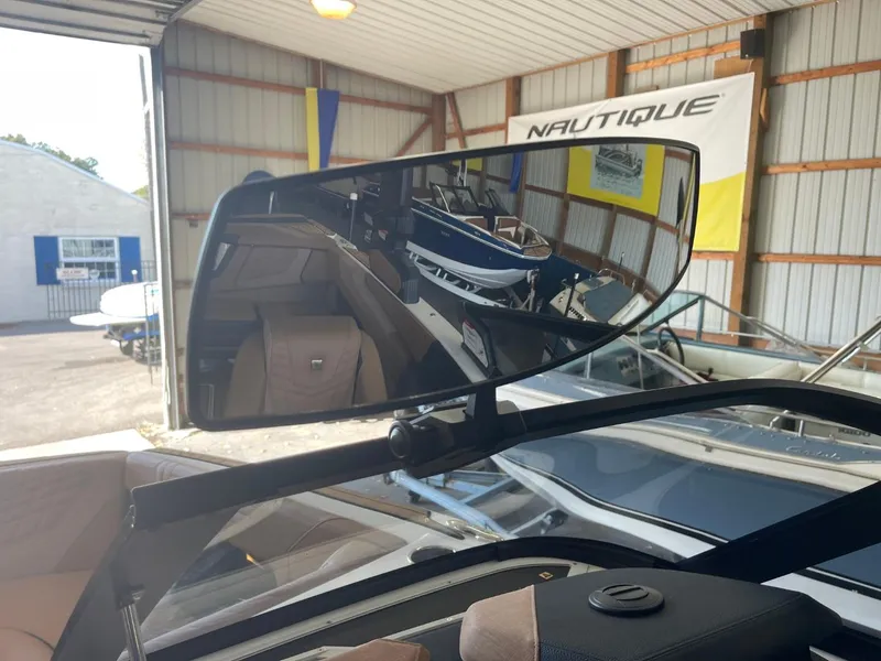 Slide: The Image of 2024 Nautique Super Air Nautique G23 rearview mirror in a showroom setting. - 15
