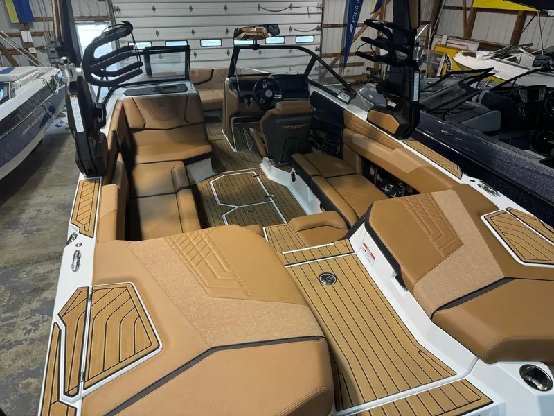 Slide: The Image of 2024 Nautique Super Air Nautique G23 interior with tan upholstery and sleek design. - 2