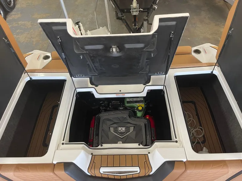 Slide: The Image of 2024 Nautique Super Air Nautique G23 engine compartment with open hatches. - 21