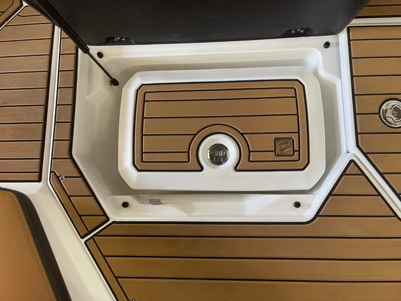 Slide: The Image of 2024 Nautique Super Air Nautique G23 deck with teak-style flooring and storage compartment. - 23