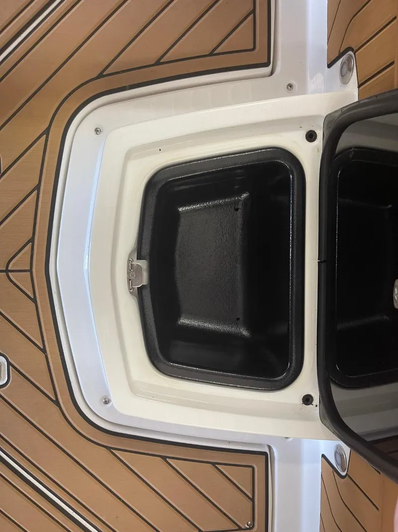 Slide: The Image of 2024 Nautique Super Air Nautique G23 storage compartment on teak deck. - 26