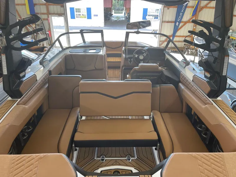 Slide: The Image of 2024 Nautique Super Air Nautique G23 interior with tan seating and modern dashboard. - 27