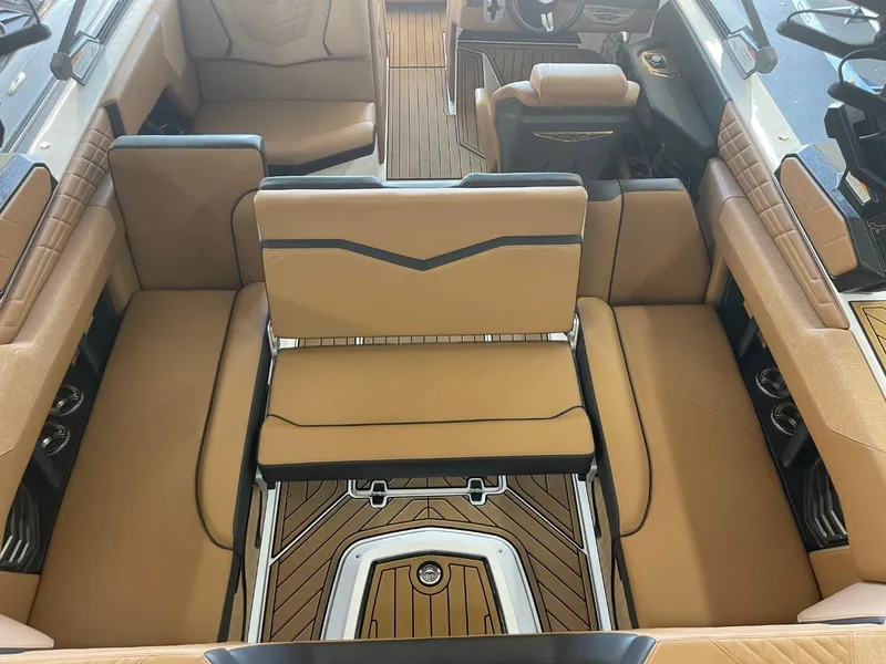 Slide: The Image of 2024 Nautique Super Air Nautique G23 interior with tan seating and sleek design. - 28