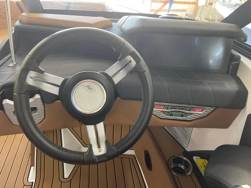 Slide: The Image of 2024 Nautique Super Air Nautique G23 steering wheel and dashboard interior. - 29