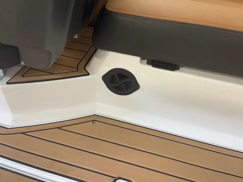 Slide: The Image of 2024 Nautique Super Air Nautique G23 interior with tan and black seating, speaker detail. - 30
