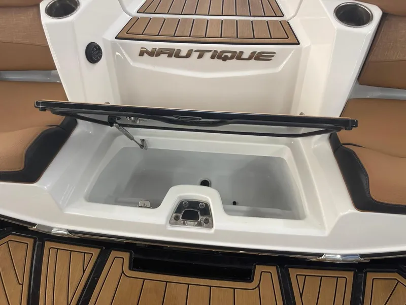 Slide: The Image of 2024 Nautique Super Air Nautique G23 boat storage compartment with teak flooring. - 31