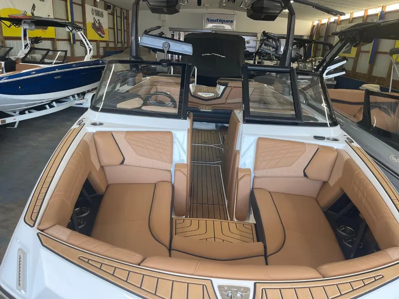 Slide: The Image of 2024 Nautique Super Air Nautique G23 boat interior with tan seating and sleek design. - 38