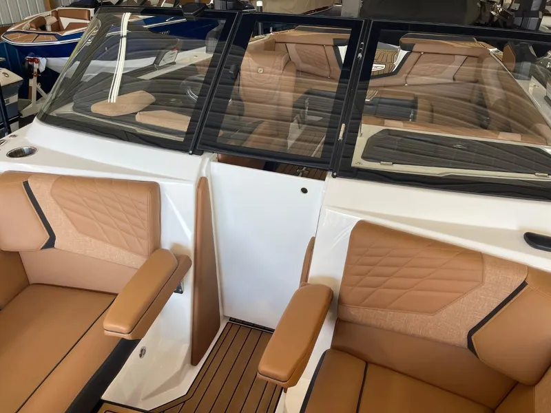 Slide: The Image of 2024 Nautique Super Air Nautique G23 interior with tan leather seats and sleek design. - 39