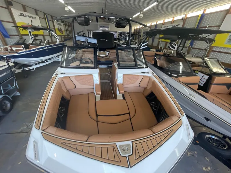 Slide: The Image of 2024 Nautique Super Air Nautique G23 boat with tan interior in showroom. - 6