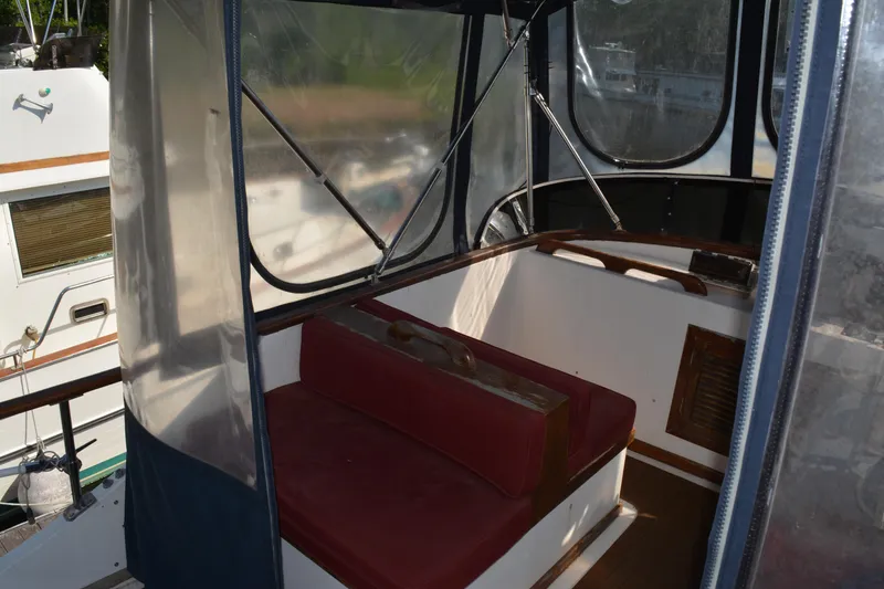 Slide: The Image of 1983 Albin Double Cabin interior with red seating and clear windows. - 10