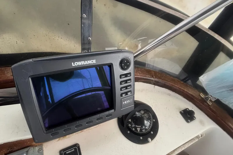 Slide: The Image of 1983 Albin Double Cabin boat dashboard with Lowrance GPS and compass. - 15
