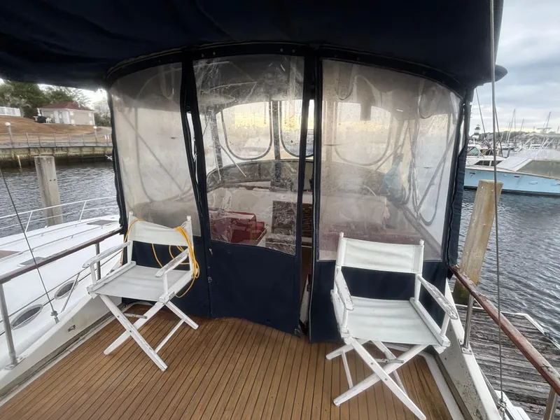 Slide: The Image of 1983 Albin Double Cabin boat deck with chairs, marina view. - 16