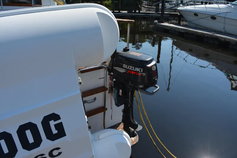 Slide: The Image of 1983 Albin Double Cabin with Suzuki outboard motor docked at marina. - 20