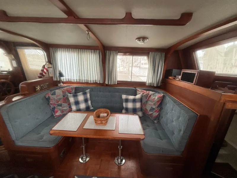 Slide: The Image of Interior of 1983 Albin Double Cabin with cozy seating and nautical decor. - 21