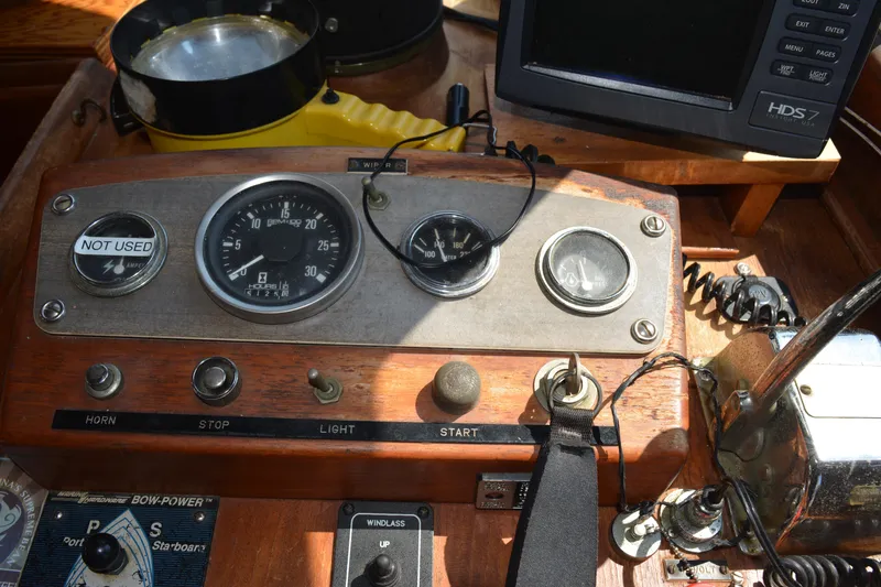 Slide: The Image of 1983 Albin Double Cabin boat dashboard with gauges and controls. - 29
