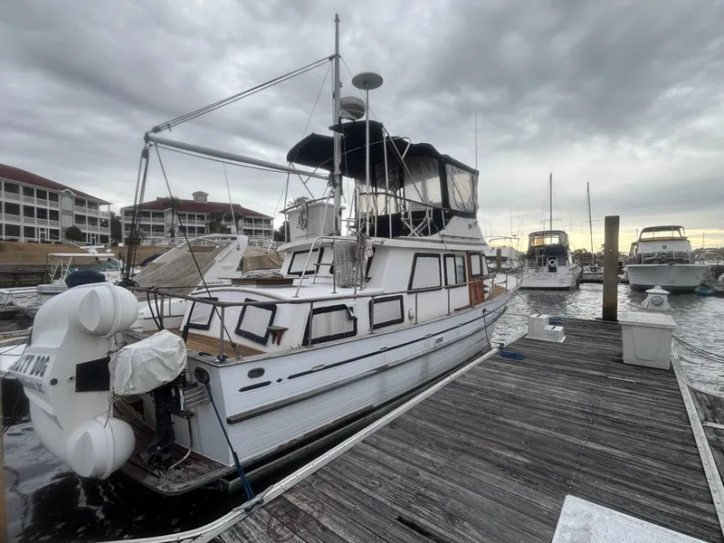 Slide: The Image of 1983 Albin Double Cabin boat docked at marina under cloudy sky. - 3