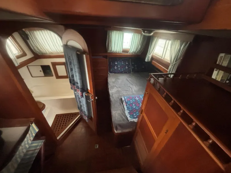 Slide: The Image of 1983 Albin Double Cabin interior with cozy bed and wooden furnishings. - 32
